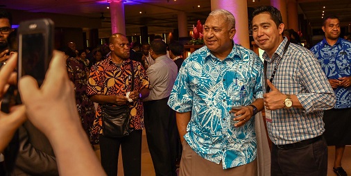Ahnivar Ancelmo Peralta, a Commonwealth Scholar from Belize, with Frank Bainimarama, the Fijian Prime Minister at 20CCEM
